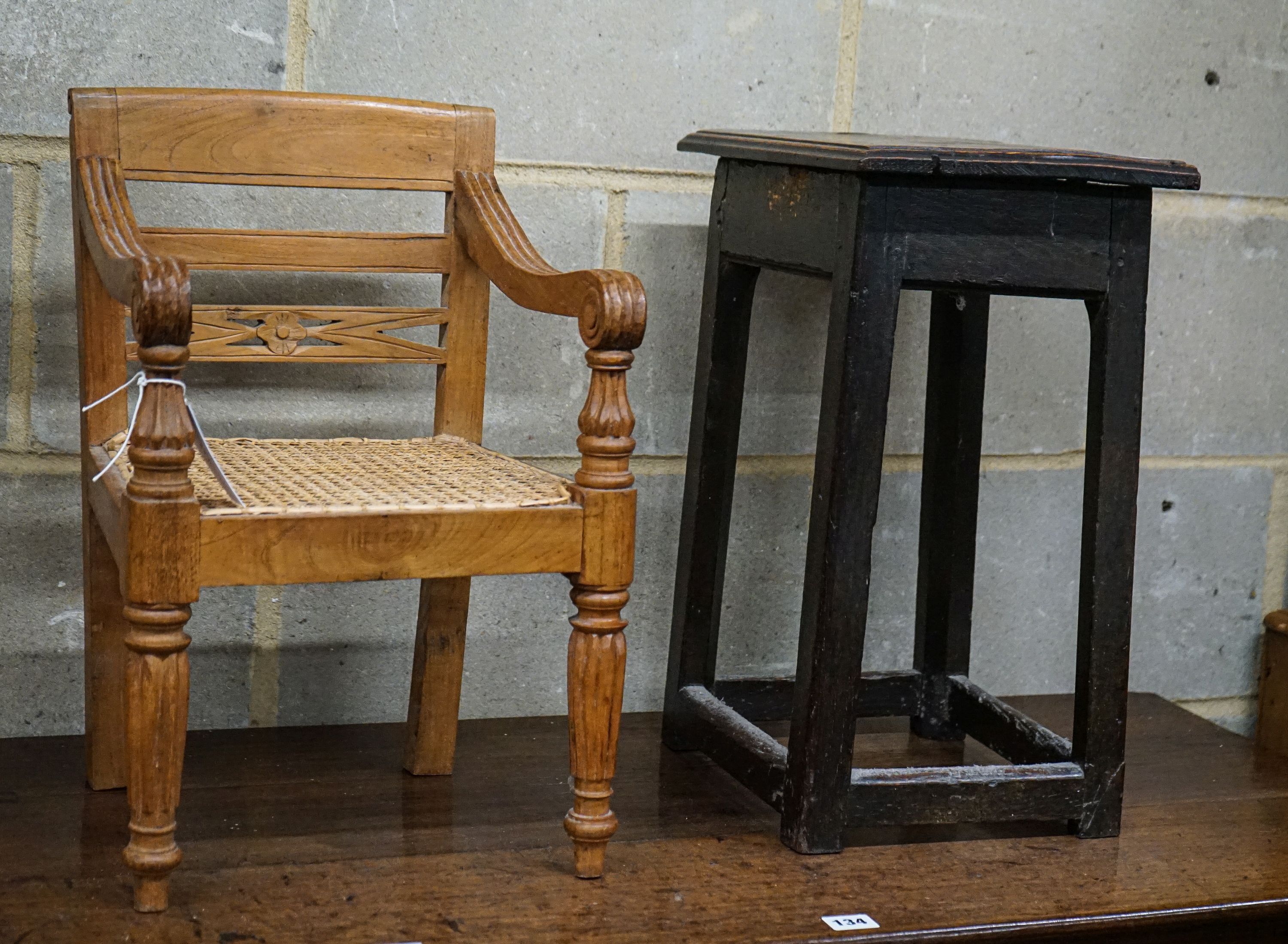 An 18th century primitive oak stool, width 34cm, depth 26cm, height 48cm and an Anglo Indian child's chair, width 31cm